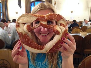 Woman Holding A Pretzel As Big As Her Face